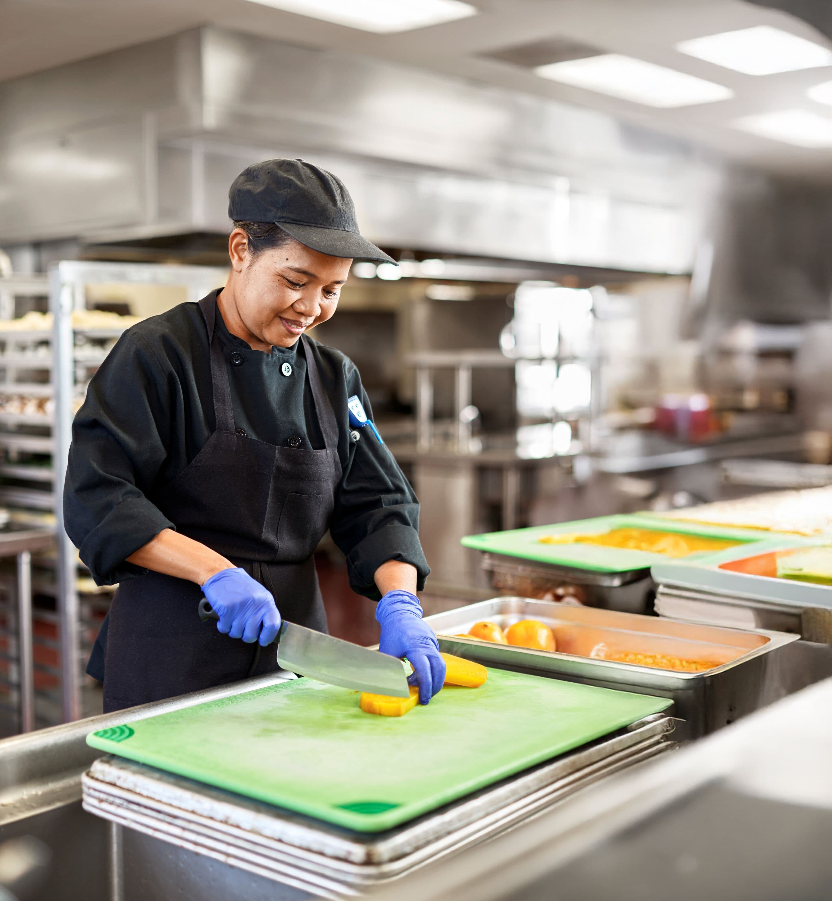 Chef slices locally sourced vegetables to create flavorful, sustainable dishes that reduce waste and showcase creative menus.